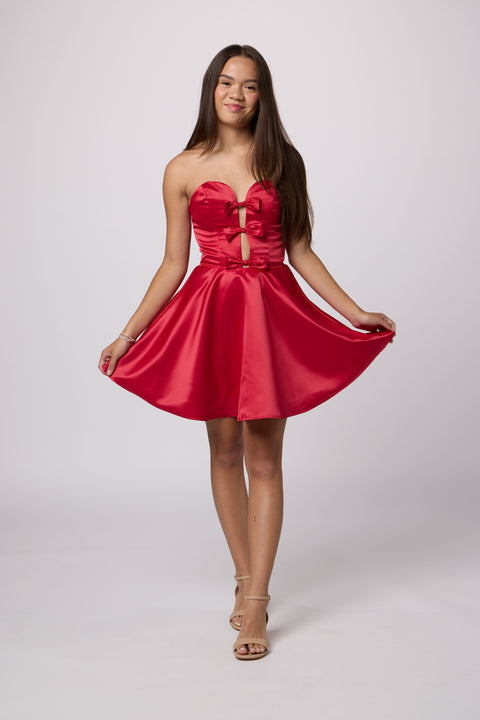 Brunette in a red strapless dress.