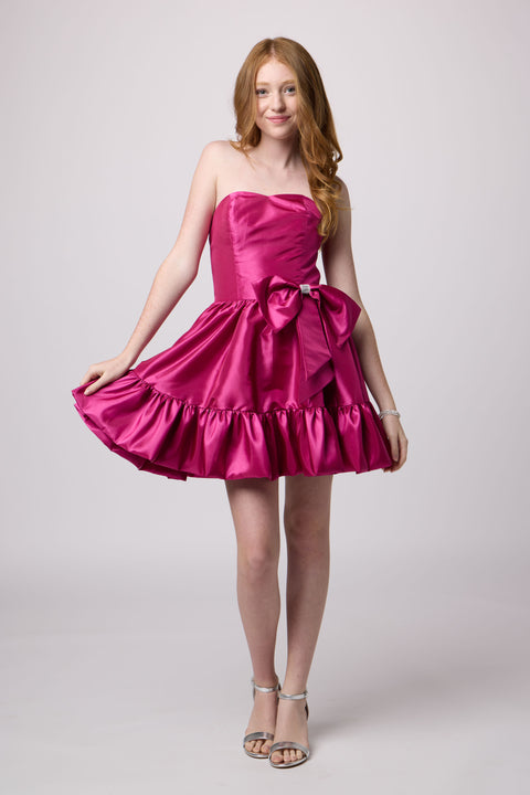 Red head girl in a magenta bubble dress.