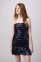 Brunette in a navy sequin dress.