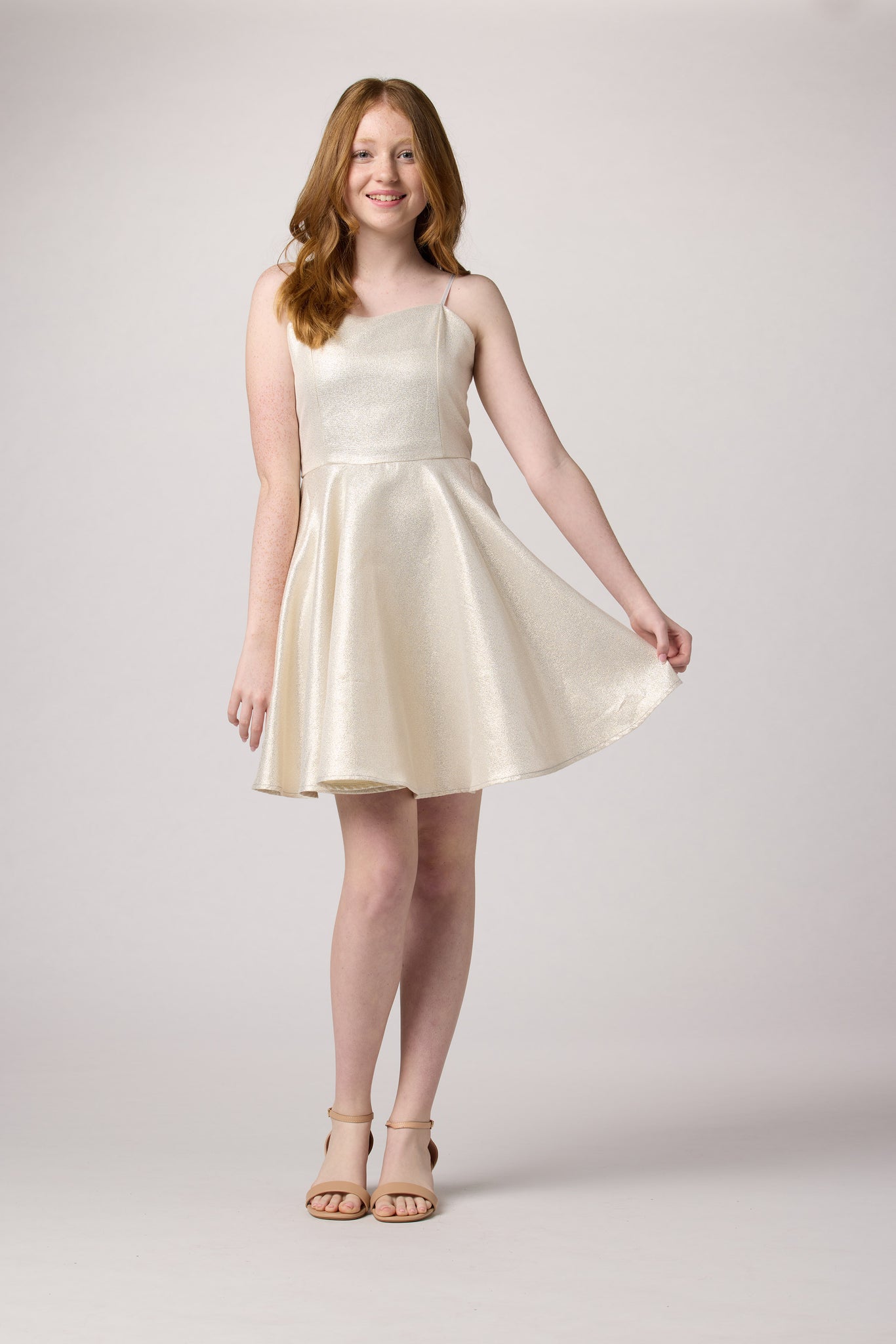 Red head in an Un Deux Ttois silver and ivory glitter fit and flare dress.