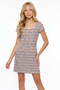 Girl in a boucle lilac dress with blonde hair.
