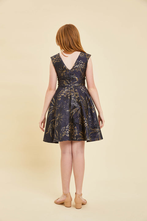 Girl in a blue floral dress back.