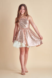 The peek-a-boo sequin dress features all over stretch sequin fabric with full circle skirt and asymmetrical skirt for a fun, twirl. Features a zipper back detailing and adjustable straps for comfort.