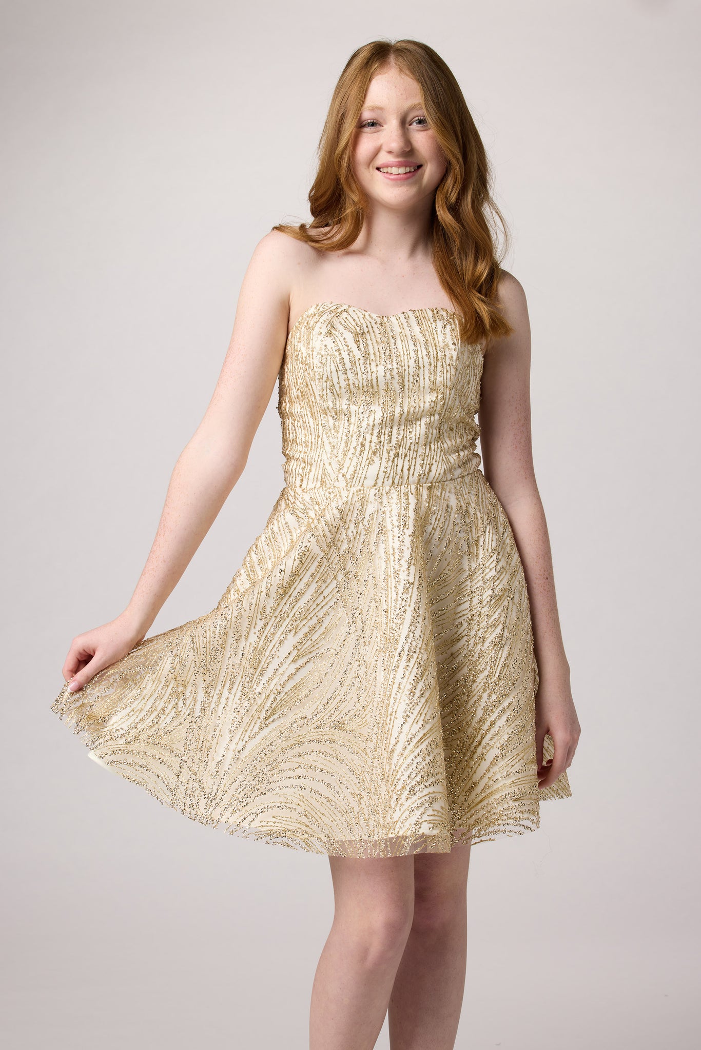 Red head girl in a gold beaded dress.