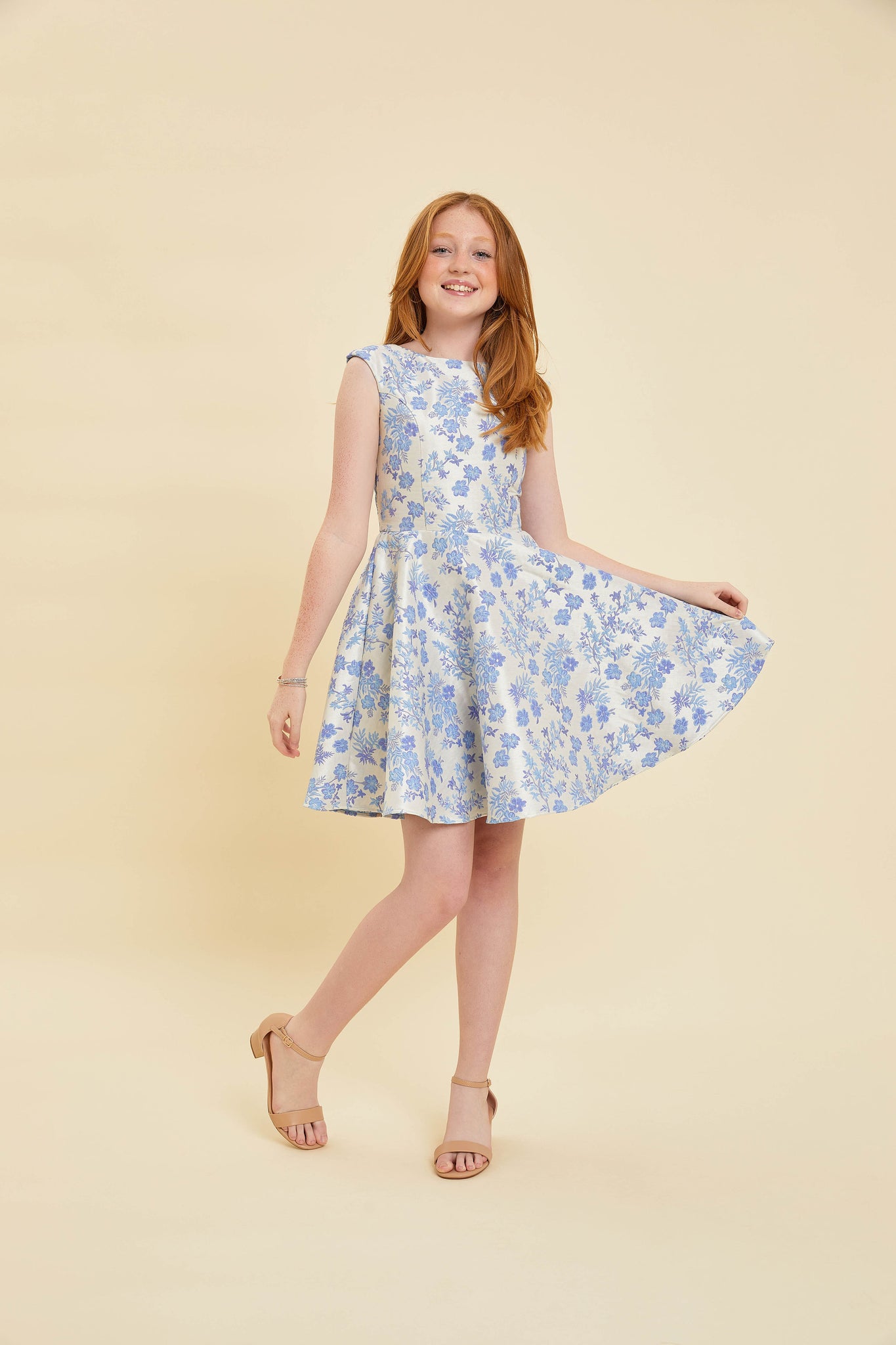 Red head girl in a floral cap sleeve Un Deux Trois dress.