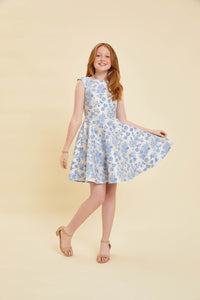 Red head girl in a floral cap sleeve Un Deux Trois dress.