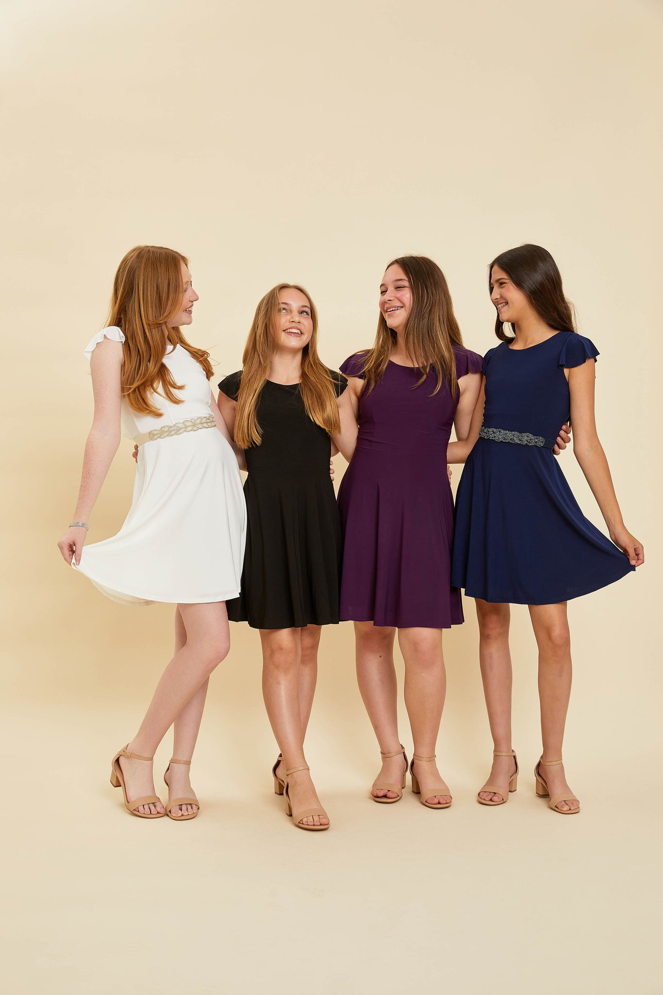 Four girls all in the flutter sleeve dress and nude heels.