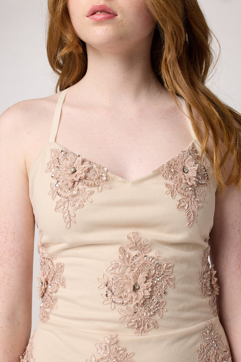 Red head in a blush pink beaded lace up back dress with nude heel.