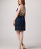 Red head in an Un Deux Trois navy beaded dress with nude heel.