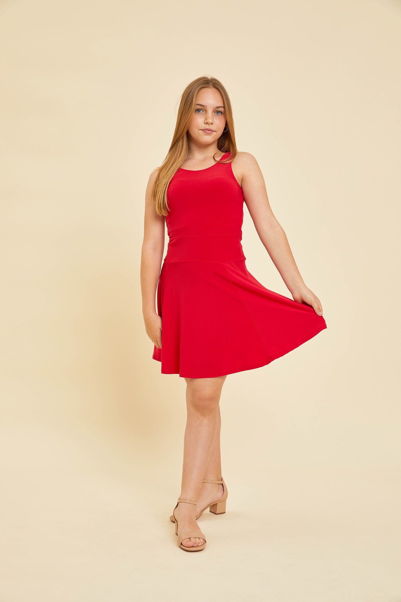 Blonde girl in a red skater dress and nude heel.
