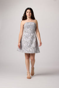Brunette girl in an Un Deux Trois silver beaded dress.