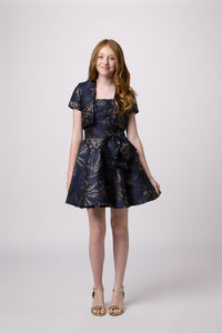 Red head girl in a navy junior strapless fit and flare bow dress.