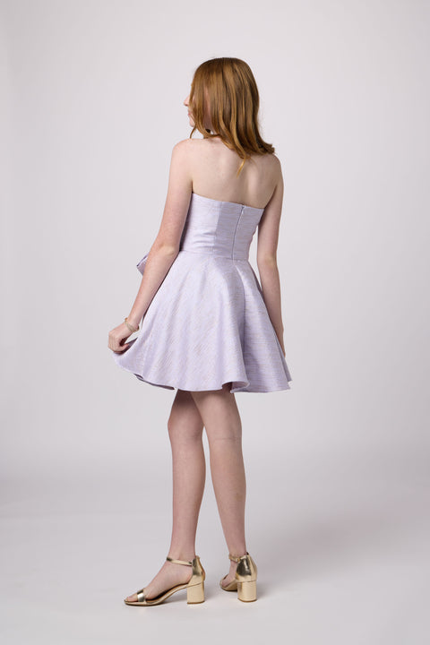 Red head in a junior strapless jacquard bow dress.