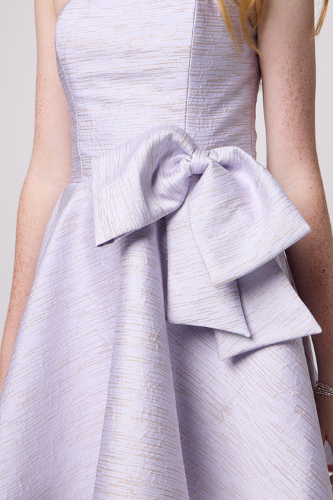 Red head in a junior strapless jacquard bow dress.