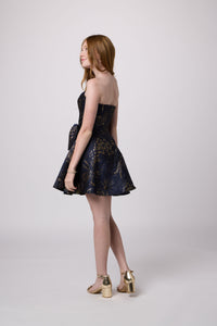 Red head girl in a navy junior strapless fit and flare bow dress.