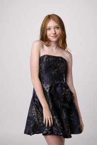 Red head girl in a navy junior strapless fit and flare bow dress.