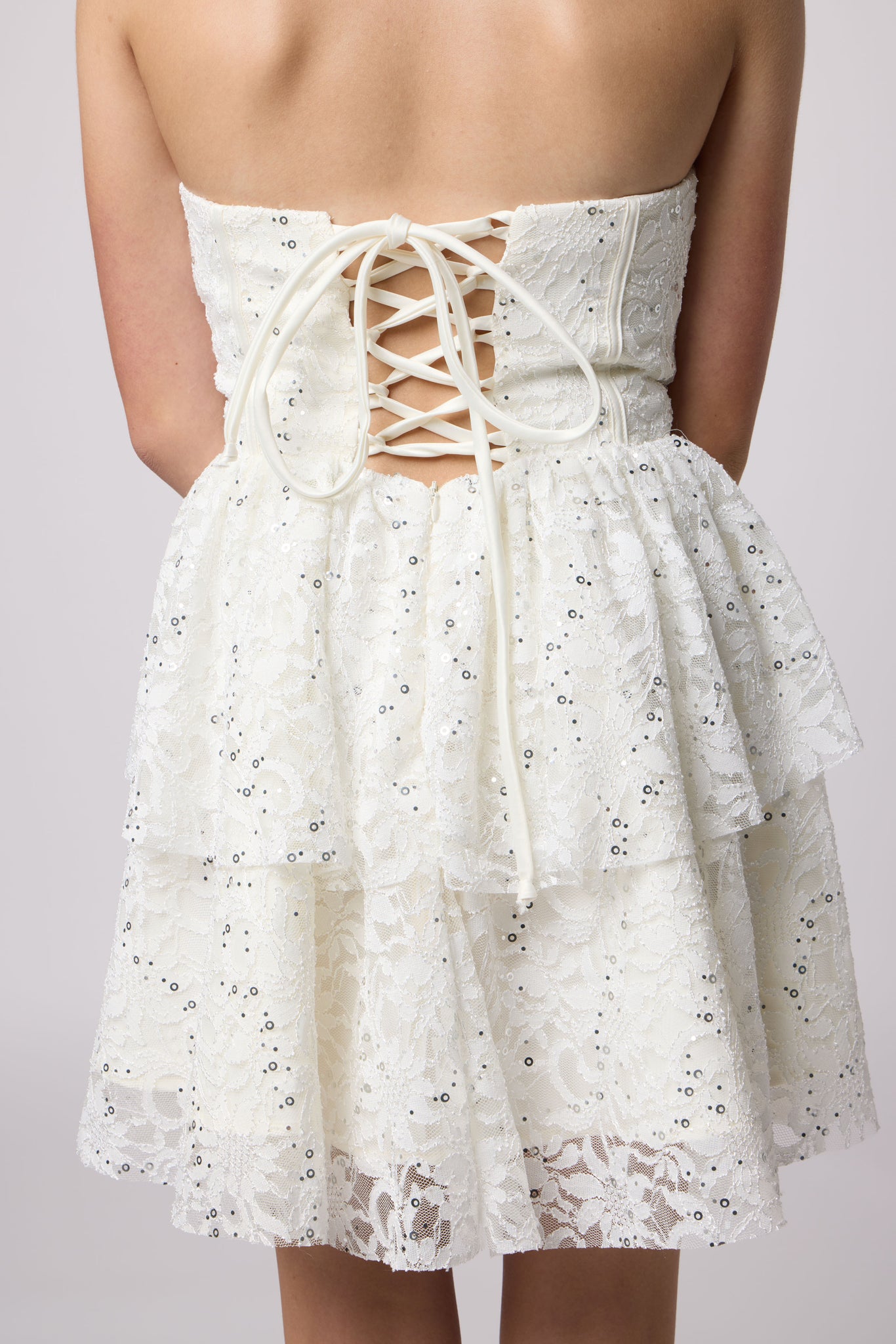 Brunette in a lace ivory dress.