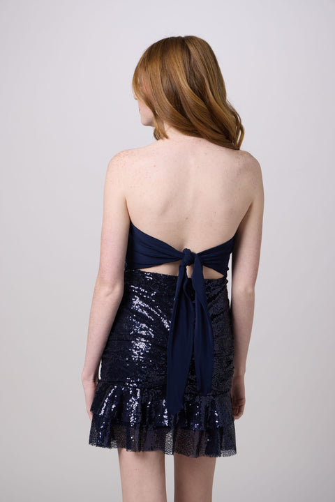 Brunette in a navy sequin dress.