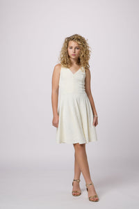 Blonde girl in an ivory Un Deux Trois dress.