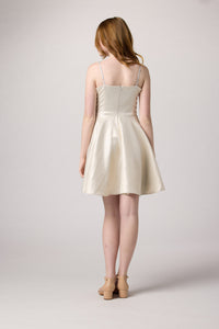 Red head in an Un Deux Ttois silver and ivory glitter fit and flare dress.
