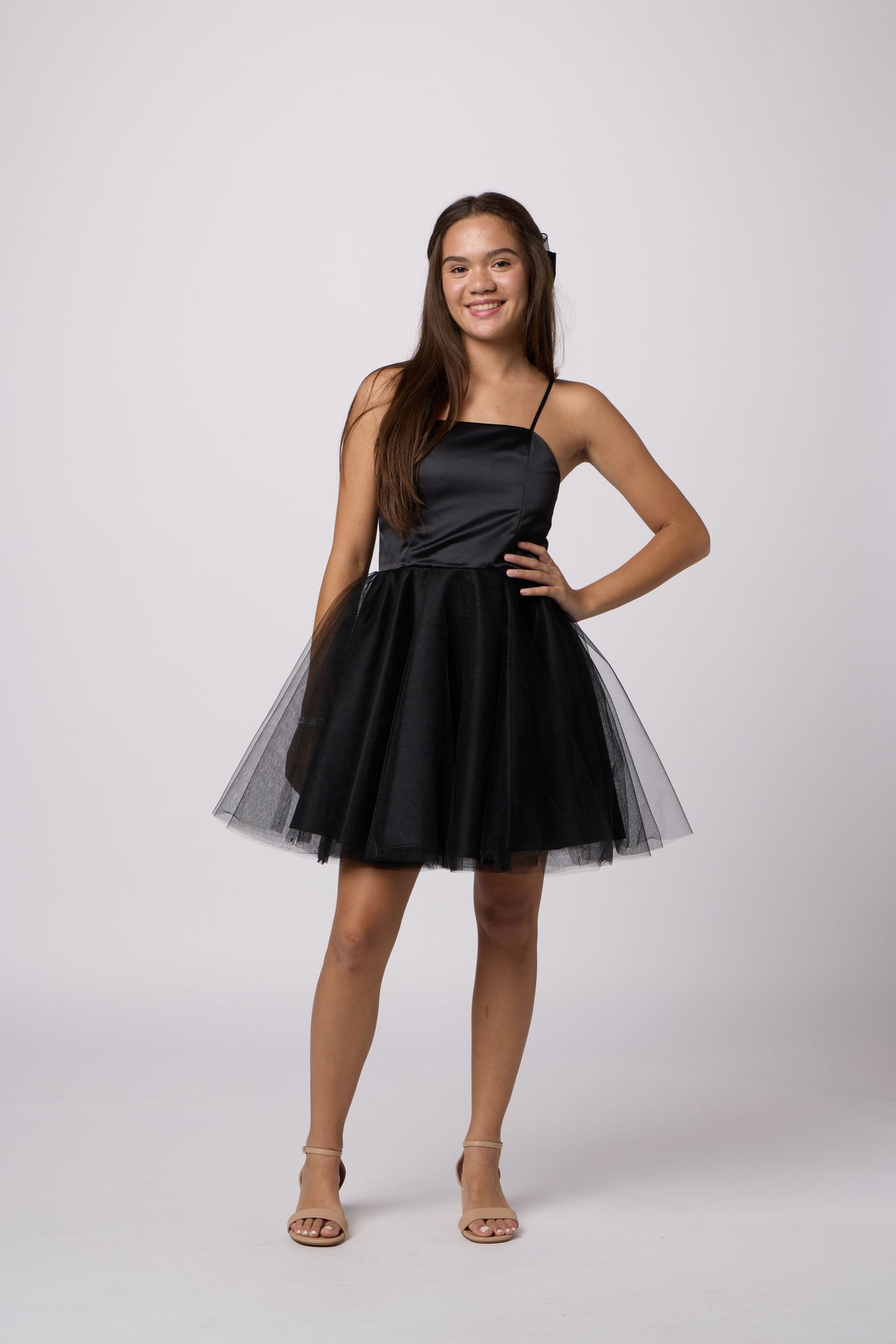 Brunette girl in an Un Deux Trois black tulle dress.