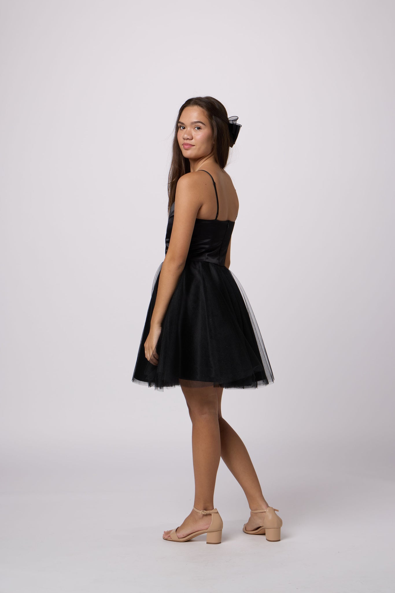 Brunette girl in an Un Deux Trois black tulle dress.