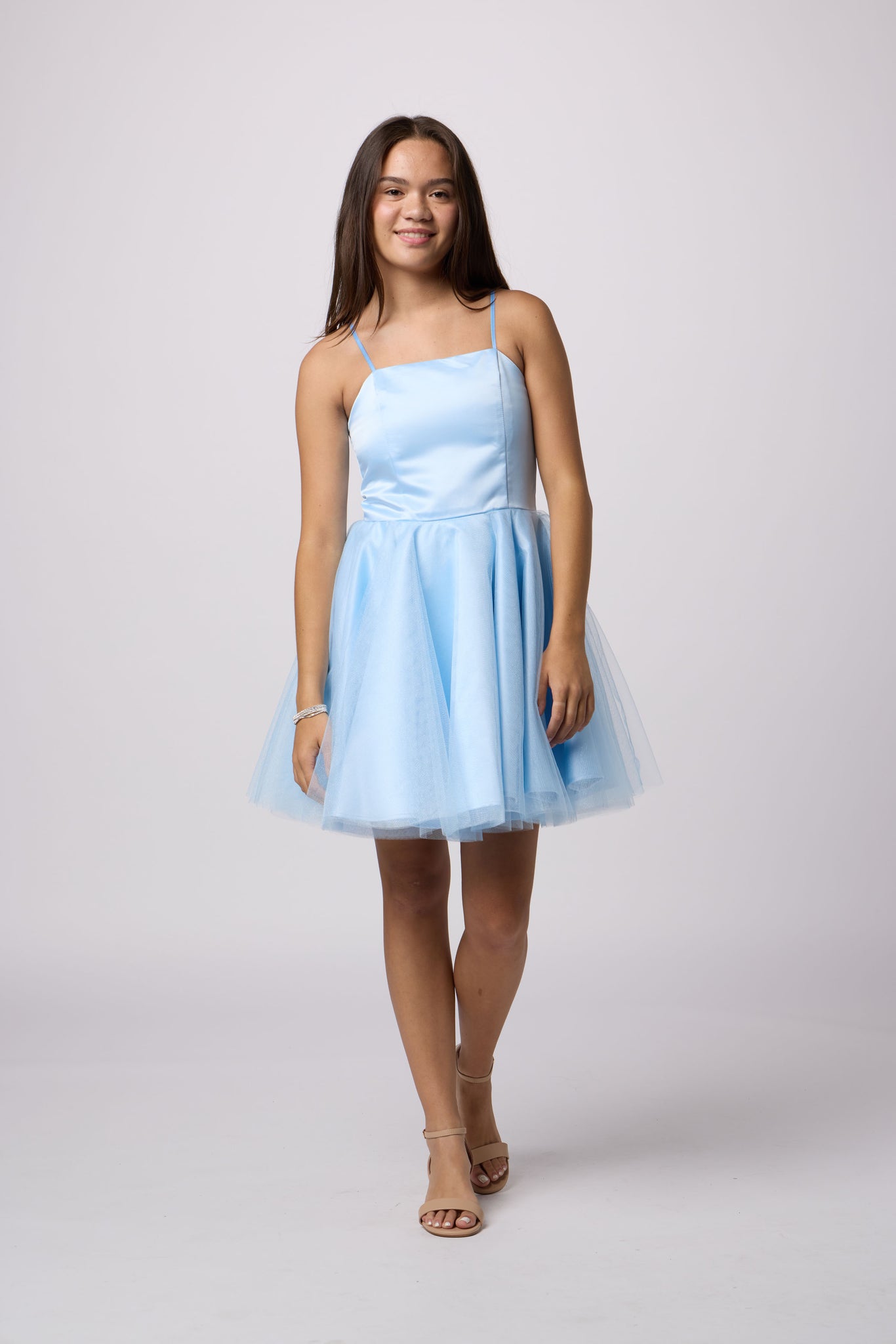 Brunette in a Un Deux Trois light blue dress.