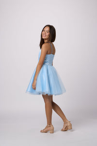 Brunette in a Un Deux Trois light blue dress.