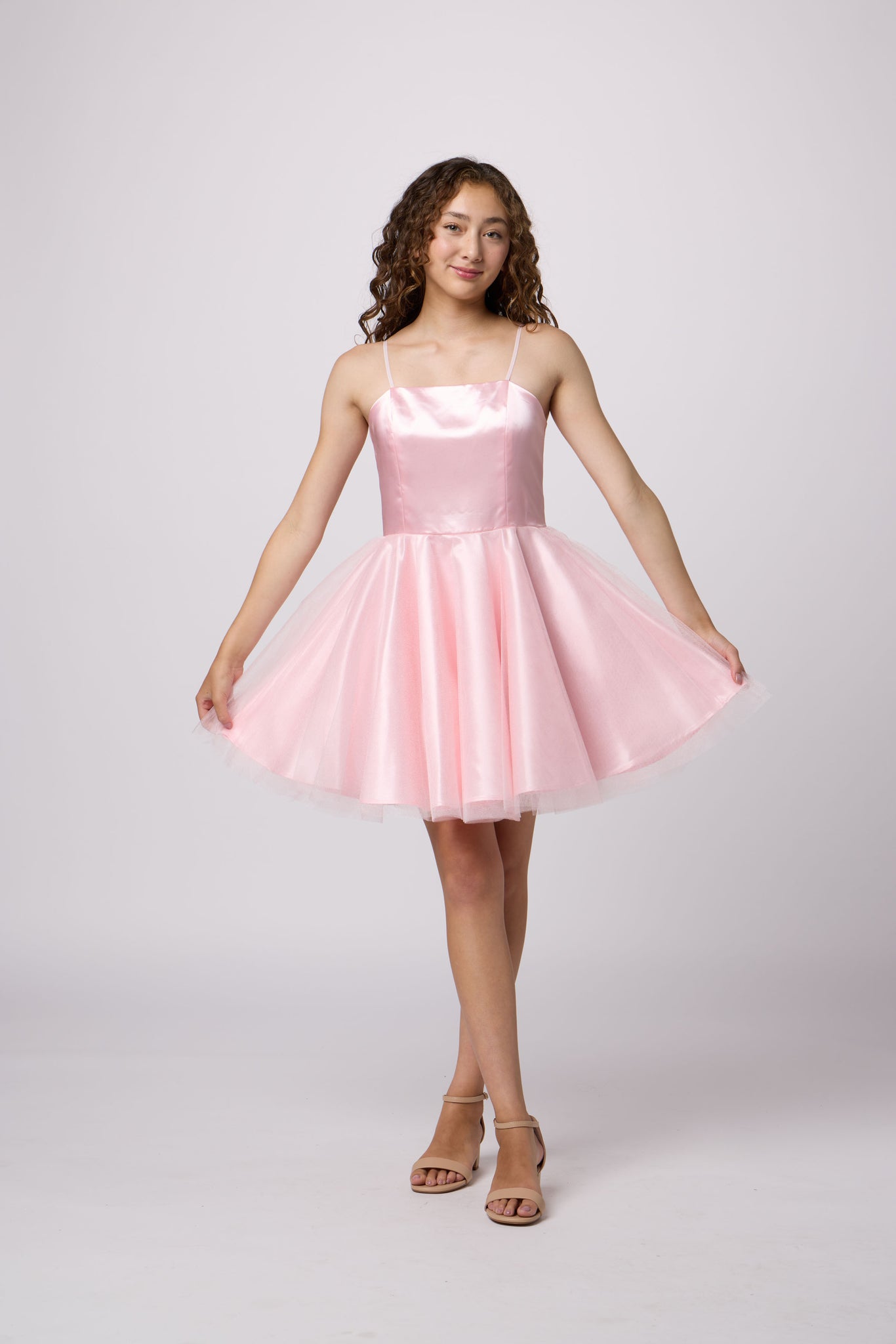 Brunette girl in an Un Deux Trois pink dress.