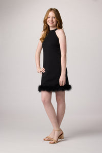 Red head girl in a black raglan halter dress with feathers.Red head girl in a black raglan halter dress with feathers.