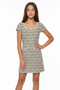 Girl in a boucle multi dress with blonde hair.
