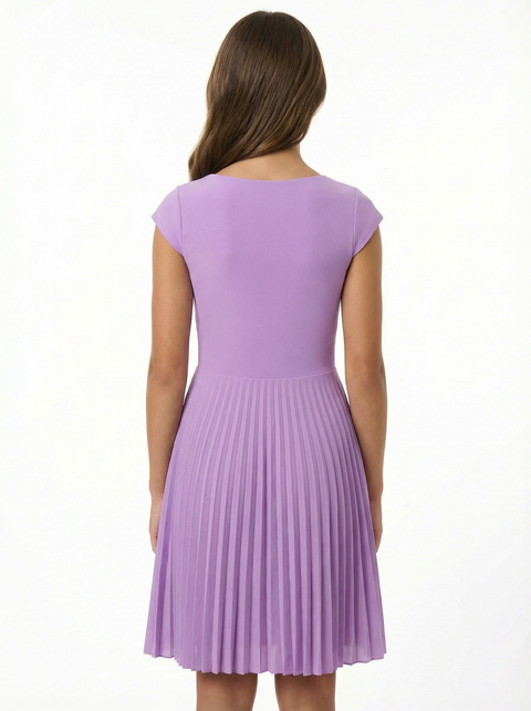Woman wearing a purple pleated dress on a white background
