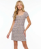 Girl in a boucle lilac dress with blonde hair.