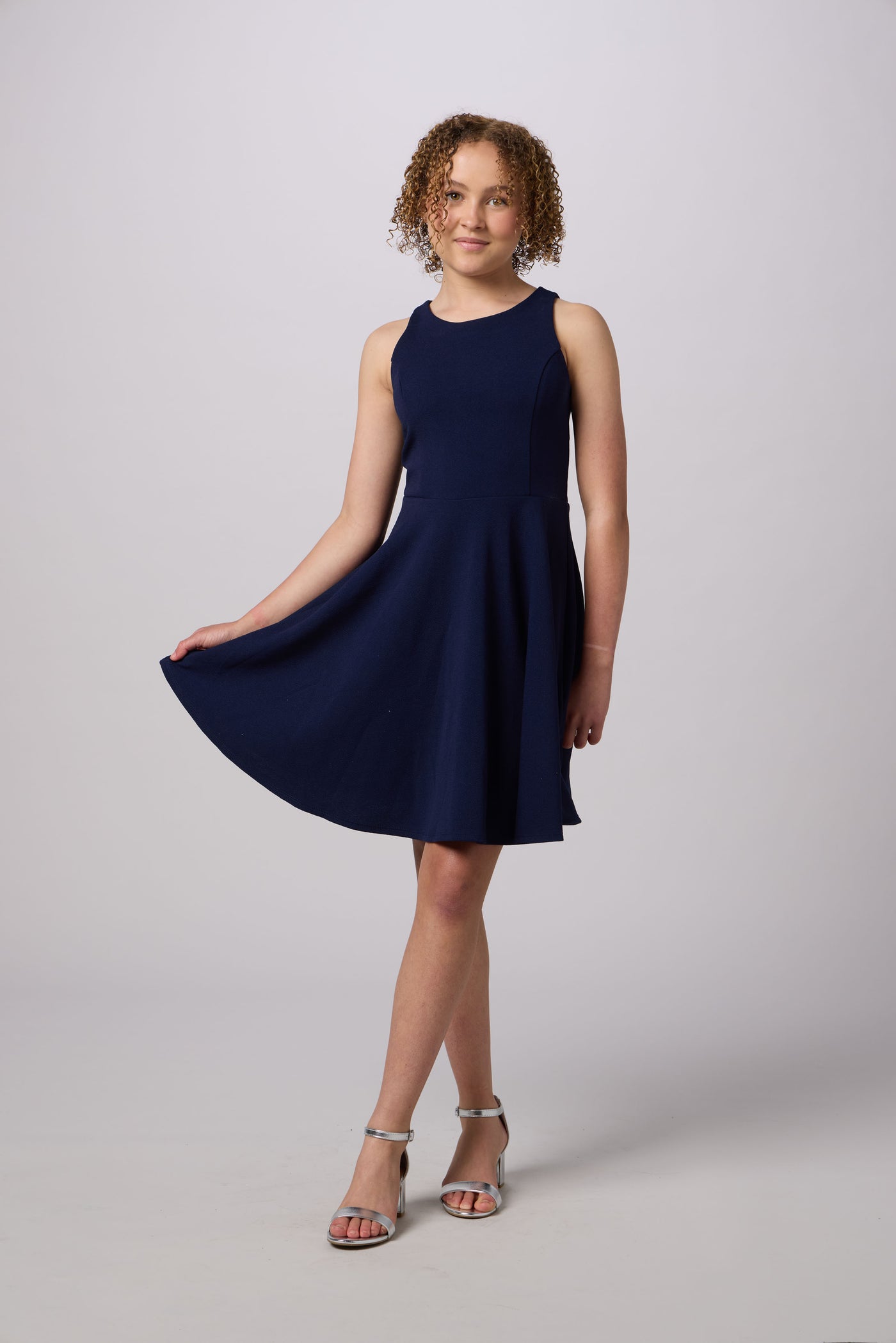 Woman wearing a navy blue dress on a white background