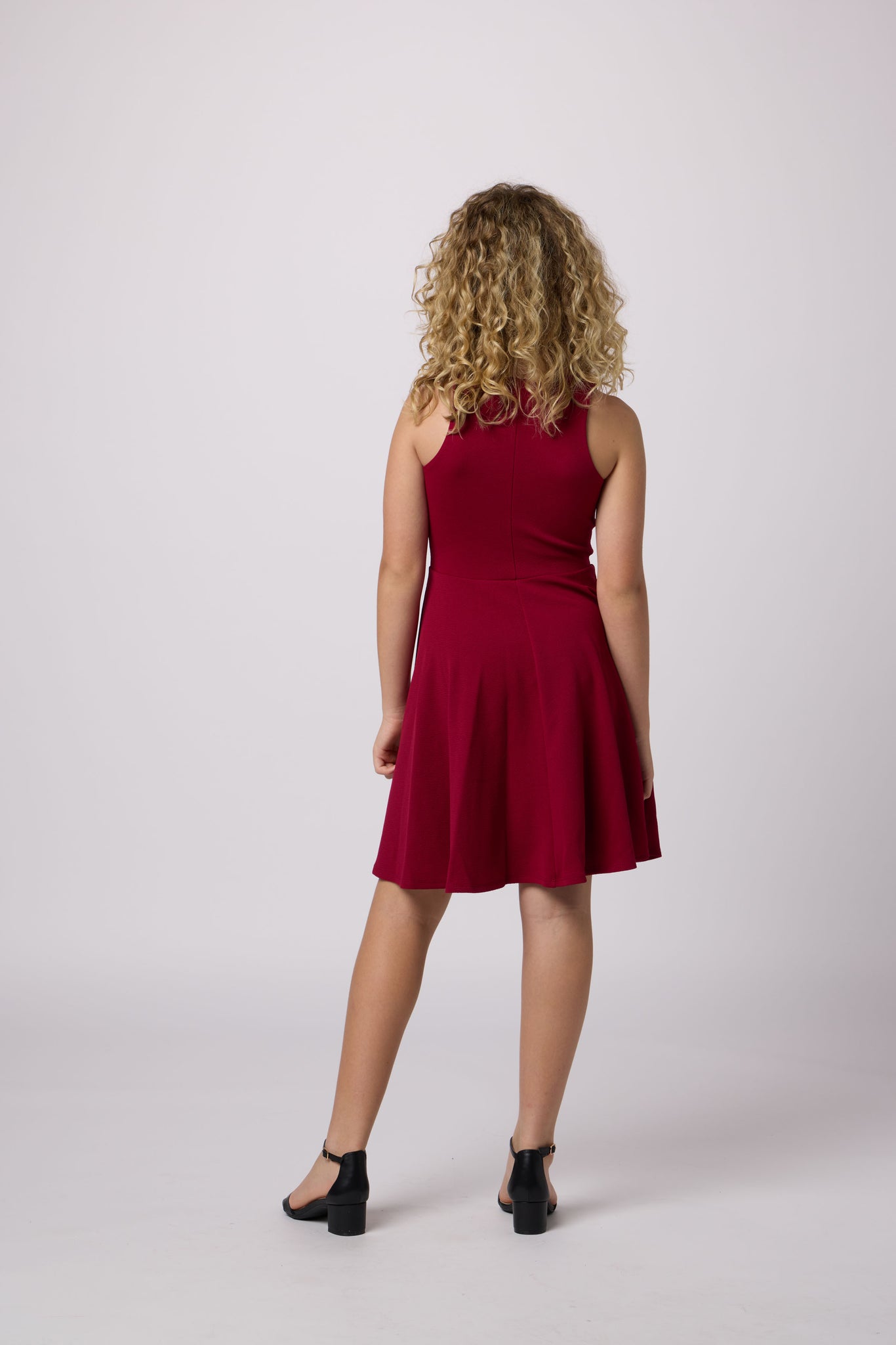 Blonde girl in a burgundy dress.