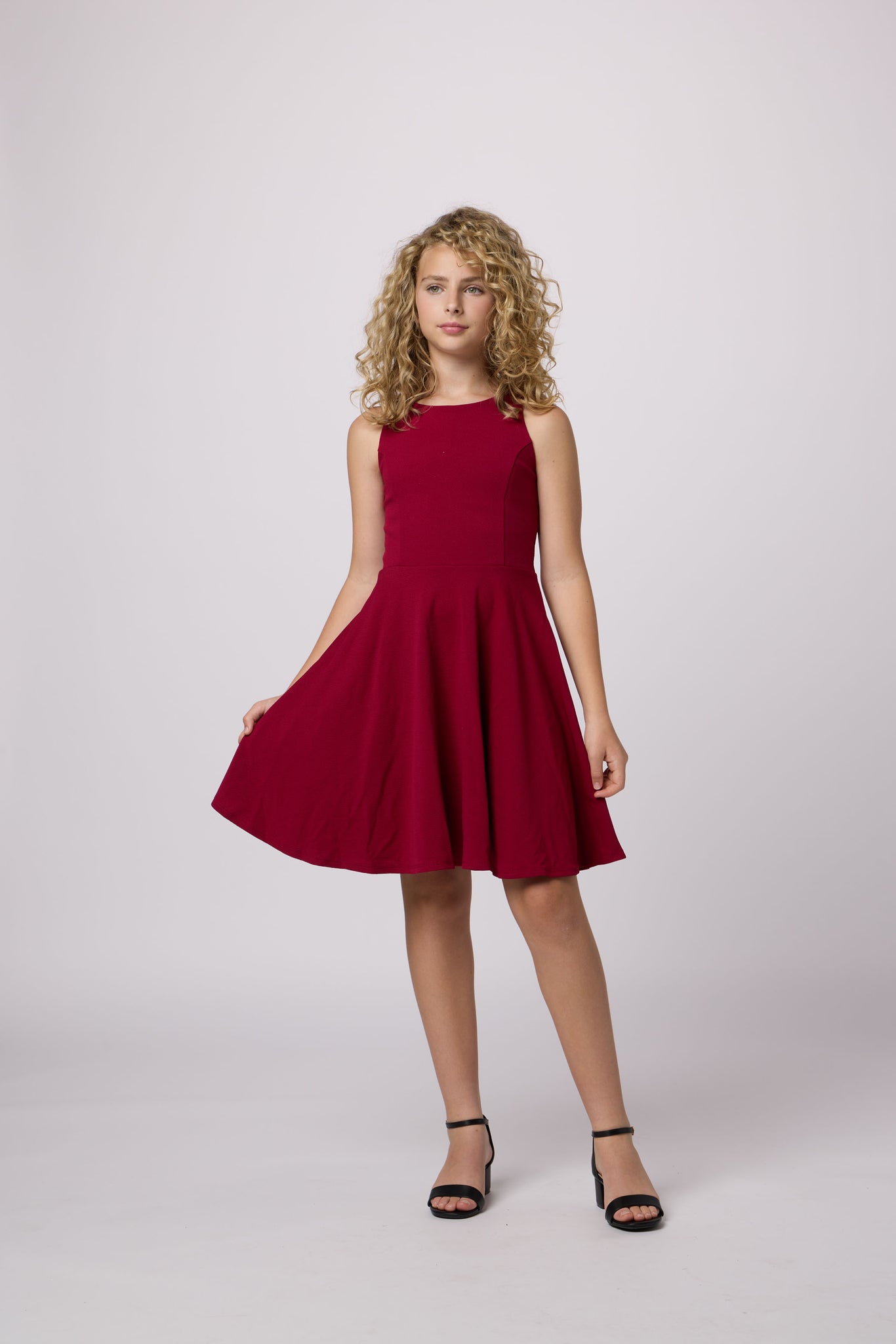 Blonde girl in a burgundy dress.