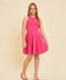 Blonde girl in a hot pink fuchsia textured racerback dress with nude heels.