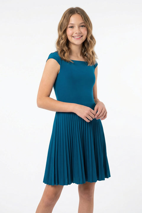 Young girl wearing a teal dress on a white background