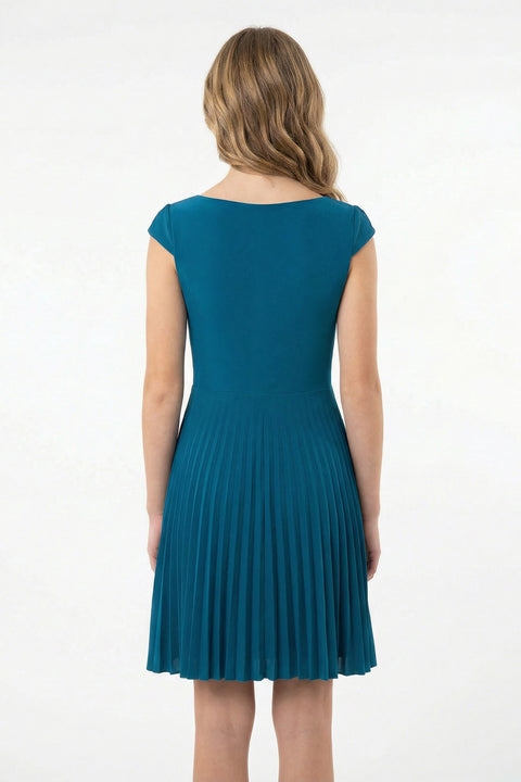 Woman wearing a teal dress on a white background