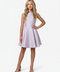 Young girl in a lilac cap sleeve dress with blonde hair in a nude shoe.