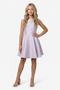 Young girl in a lilac cap sleeve dress with blonde hair in a nude shoe.