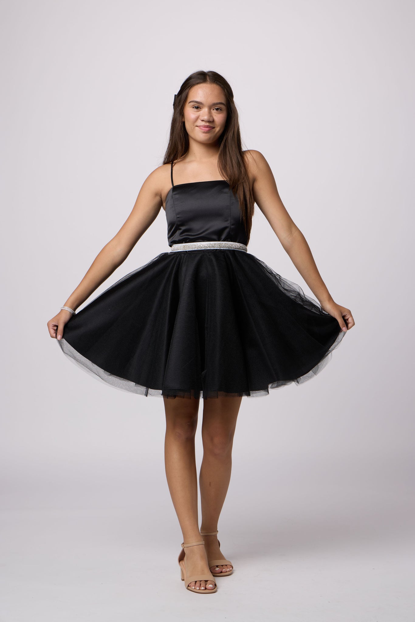 Brunette girl in an Un Deux Trois black tulle dress.