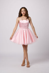 Brunette girl in an Un Deux Trois pink dress.