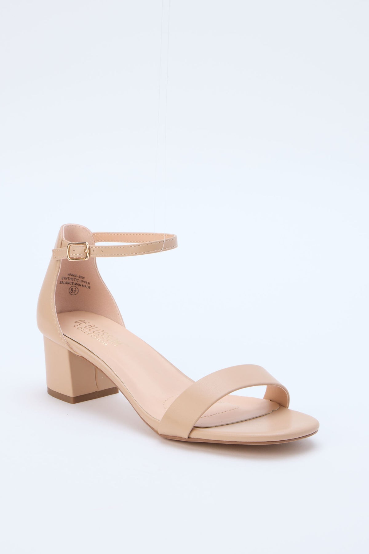 Beige sandal with a block heel on a light gray background