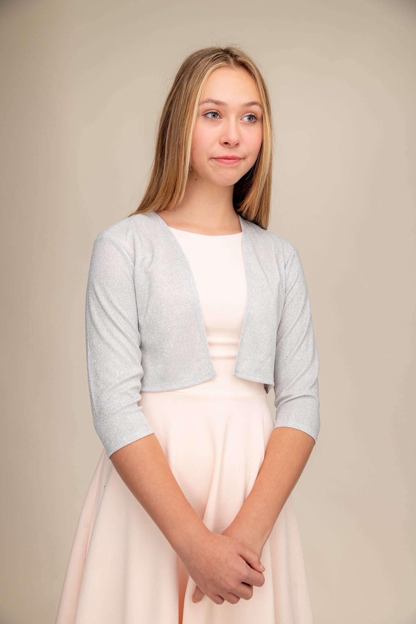 Girl wearing a silver bolero jacket. 