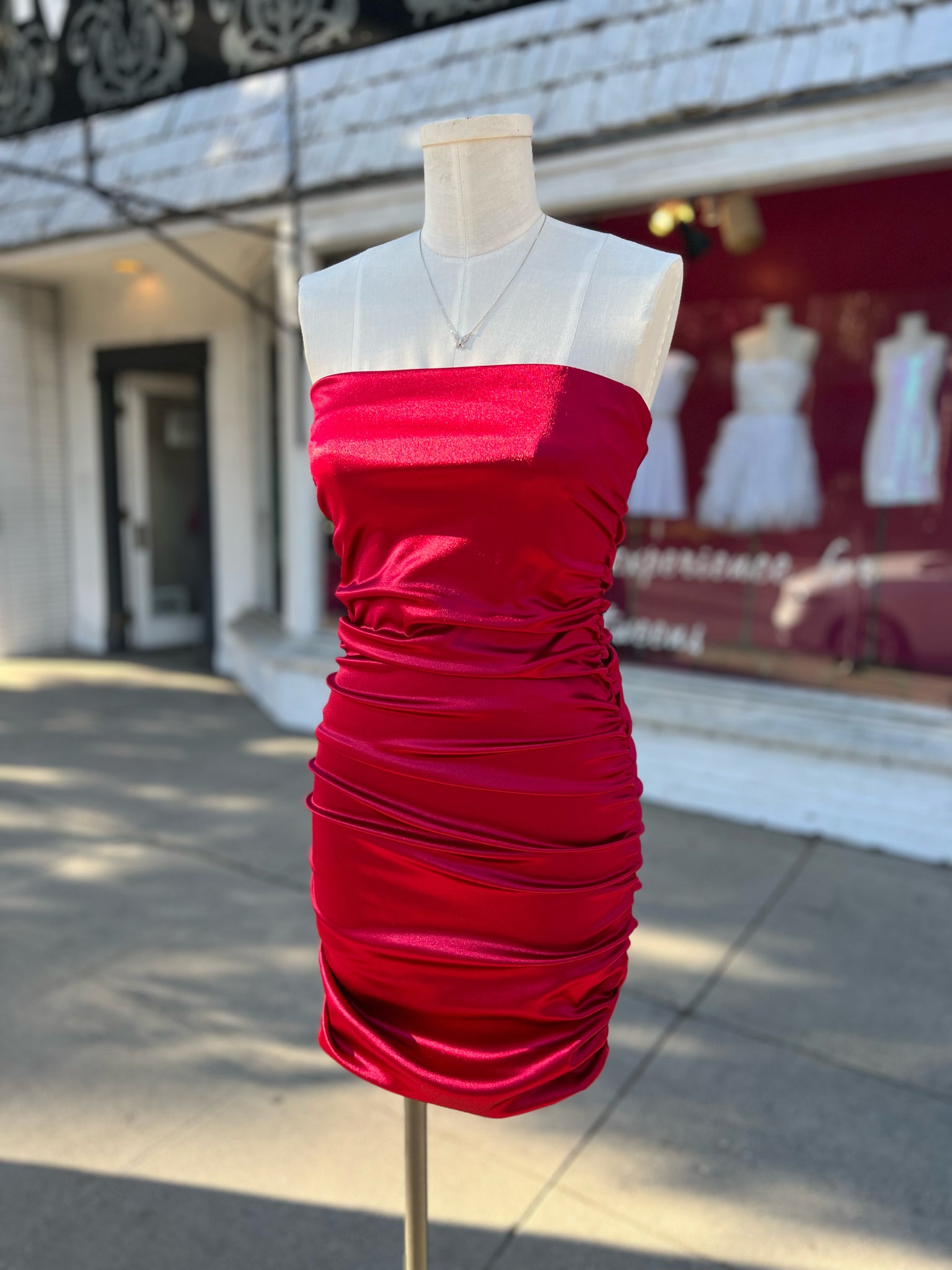 Red satin strapless ruched dress.