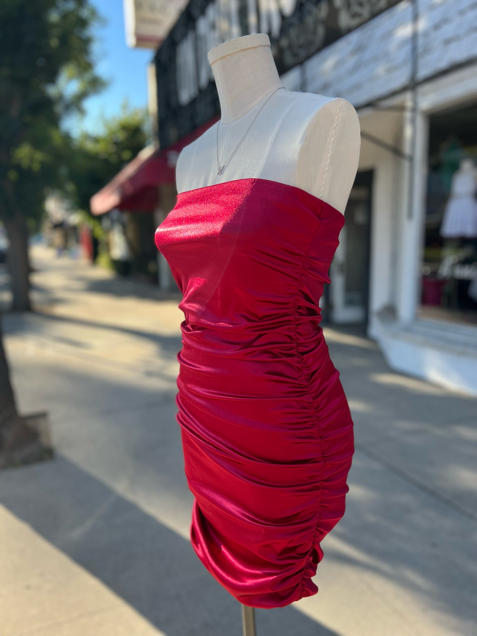 Red satin strapless ruched dress.
