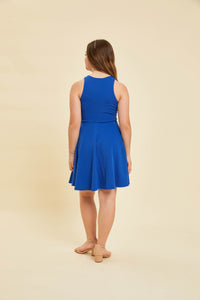 Brunette in a cobalt blue dress with nude heel.