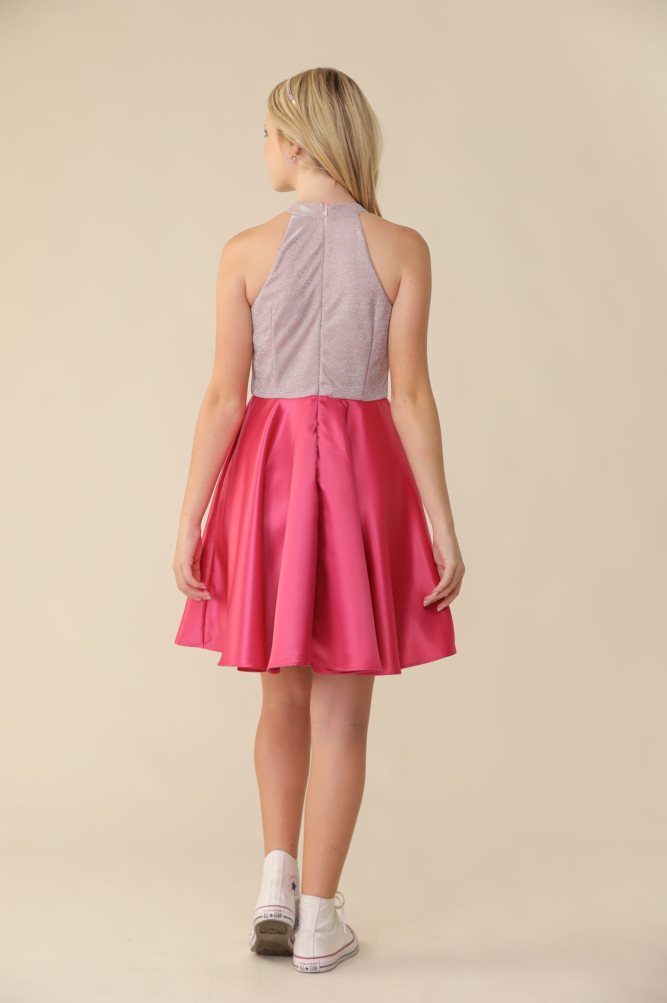Halter style fit and flare dress with a stretchy, glitter bodice and non-stretch satin skirt in fuchsia pink back.