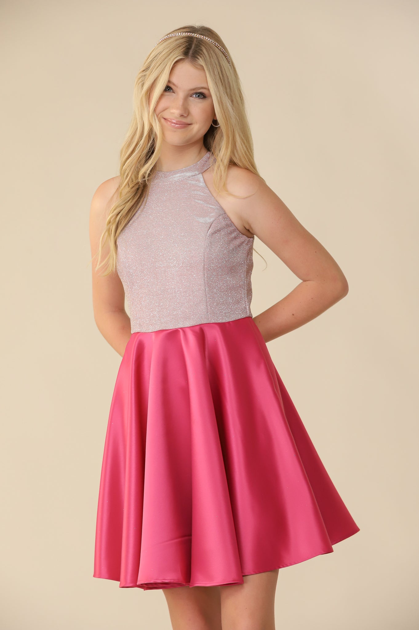 Halter style fit and flare dress with a stretchy, glitter bodice and non-stretch satin skirt in fuchsia pink. 